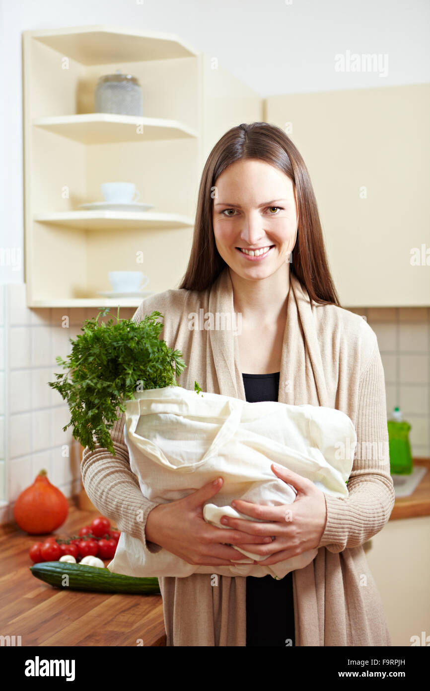 Attractive woman carrying shopping bag in kitchen Stock Photo Alamy