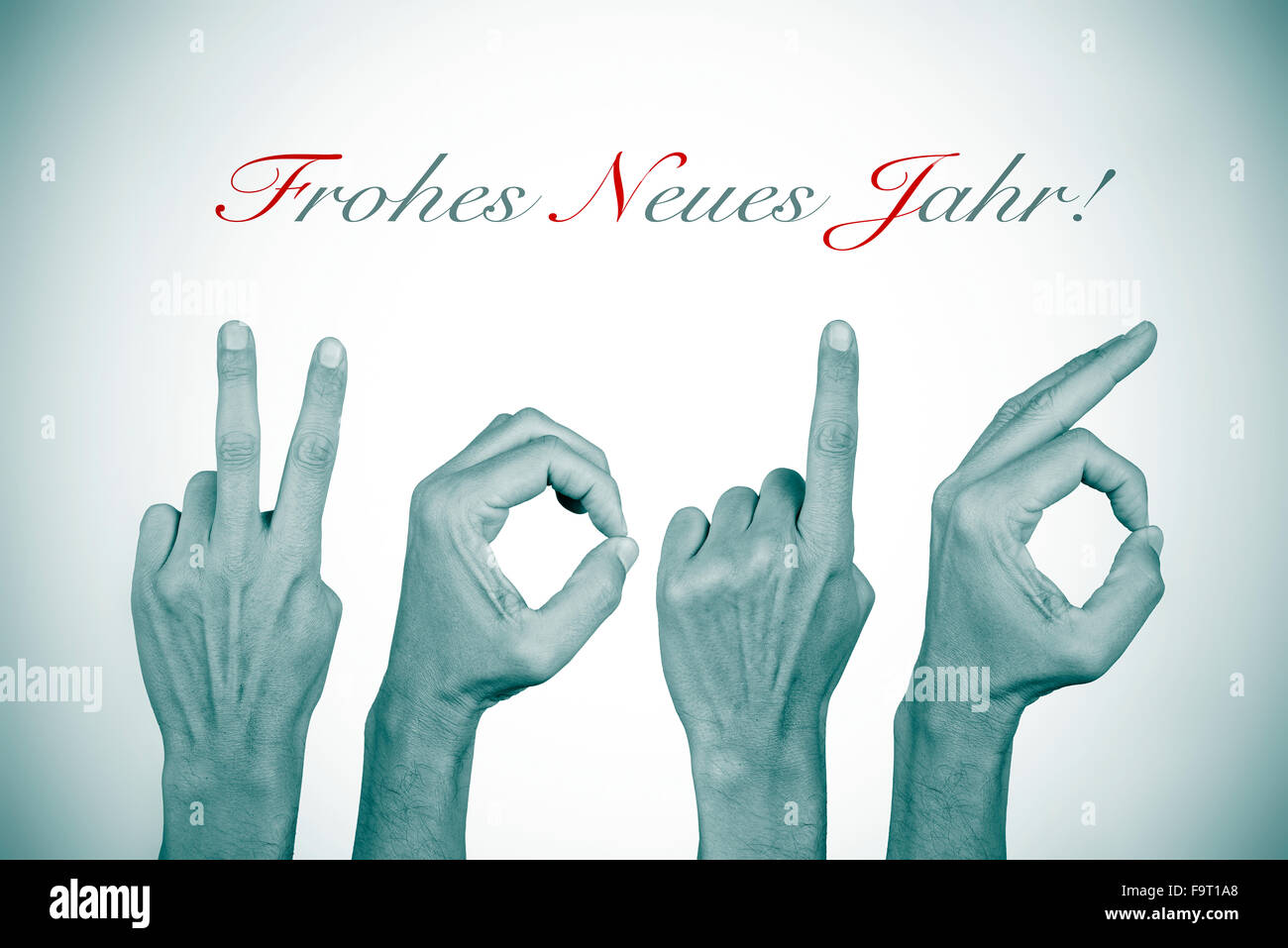 man hands forming the number 2016, as the new year, and the text frohes neues jahr, happy new year in german, in black and white Stock Photo