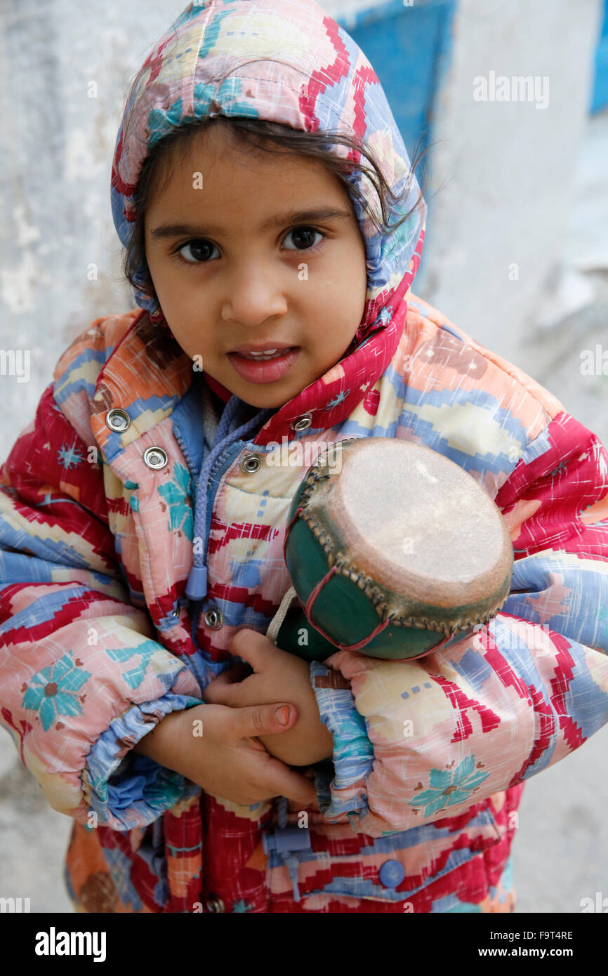 Girl carrying a drum Stock Photo