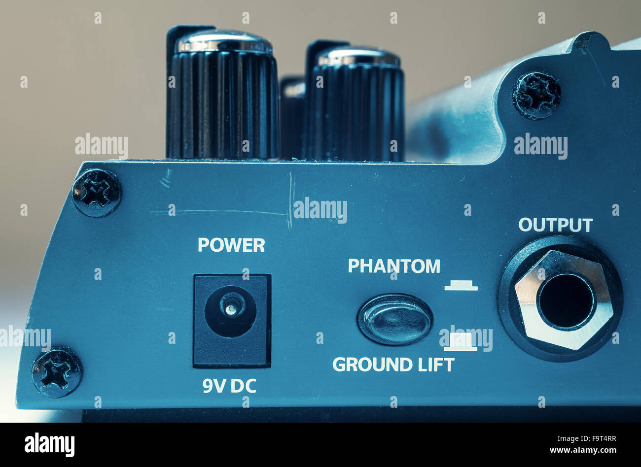 Details of a guitar pedal, part with power, phantom and output ports. Stock Photo