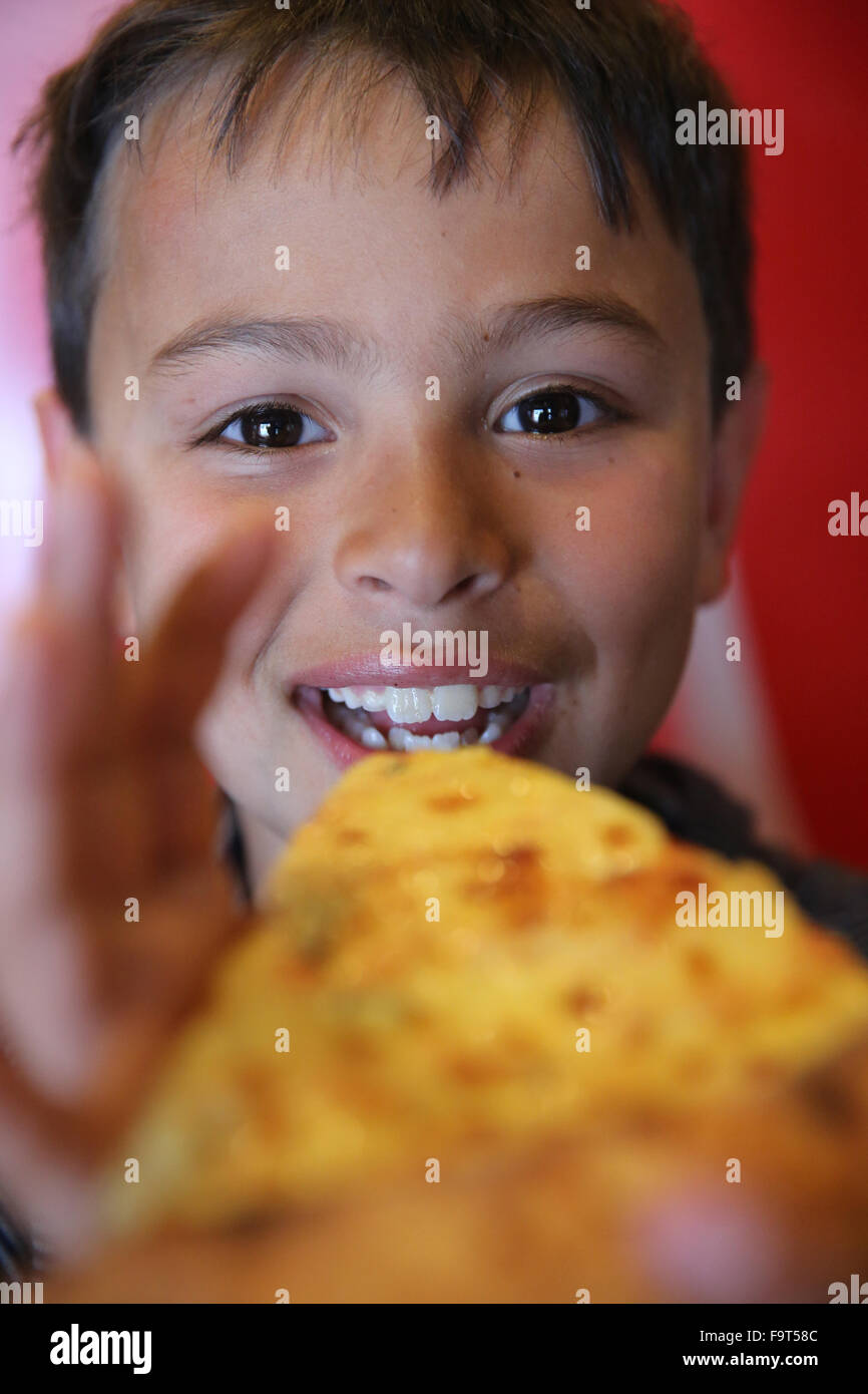 8yearold boy eating pizza Stock Photo Alamy