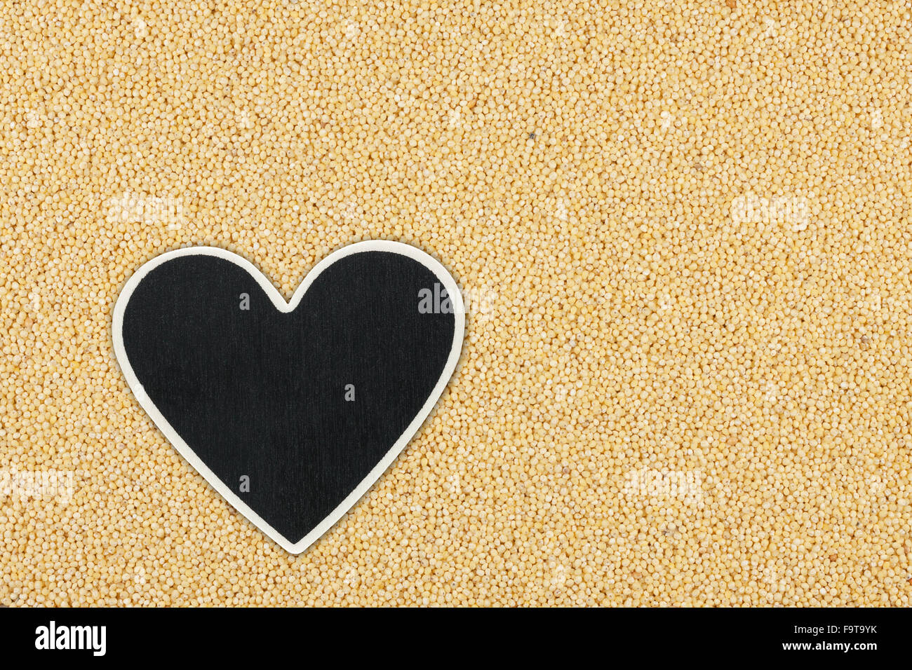 Heart pointer, the price tag lies on millet,  with space for your text Stock Photo