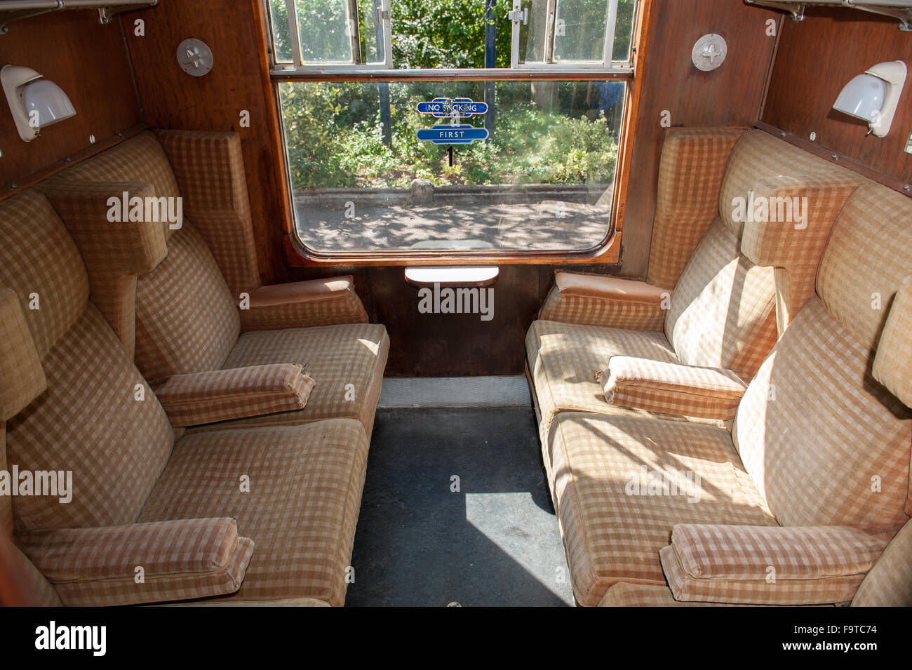Inside a vintage British passenger train carriage with seating Stock Photo
