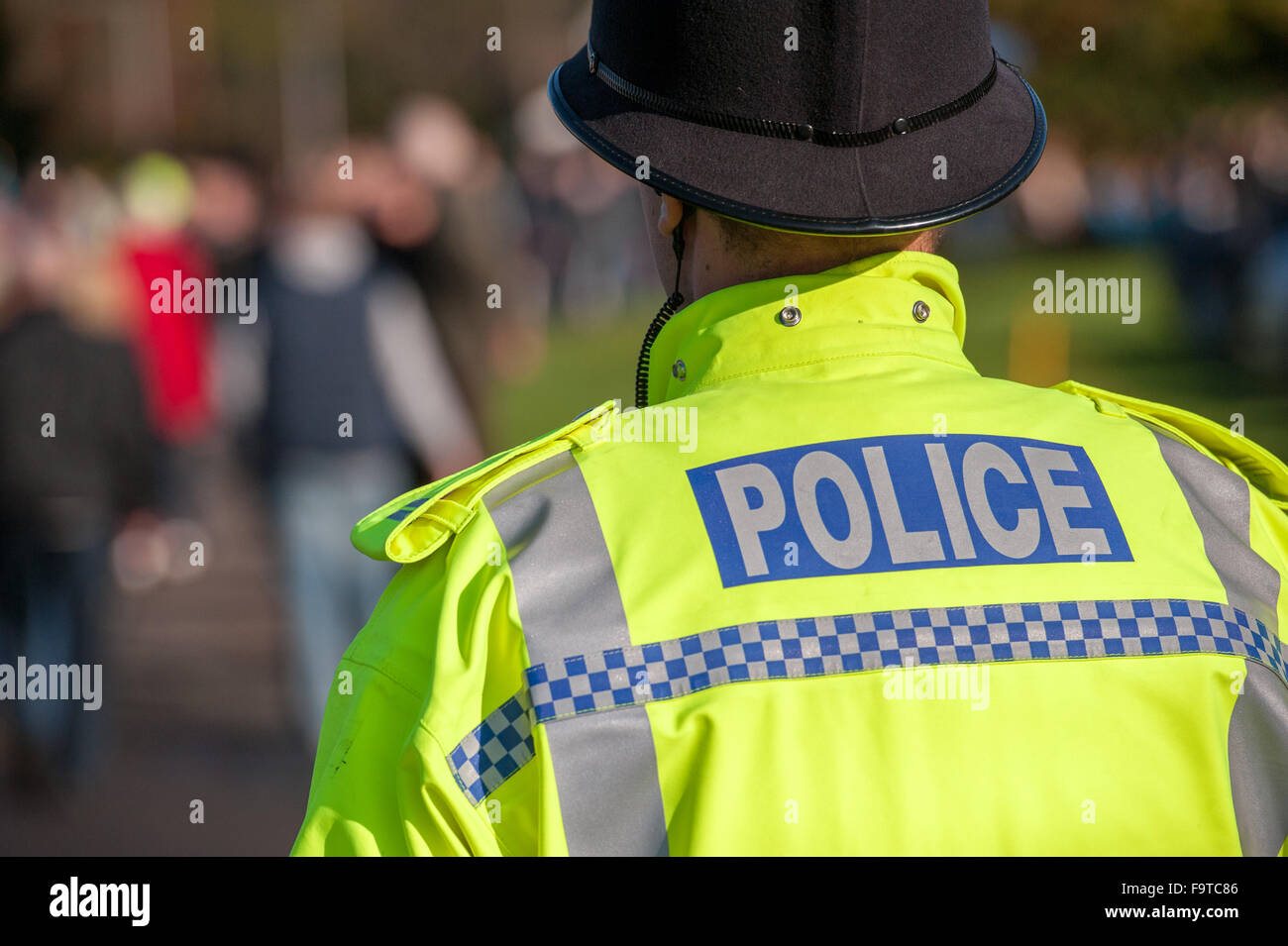 British police officer uniform with high visible yellow jacket Stock Photo
