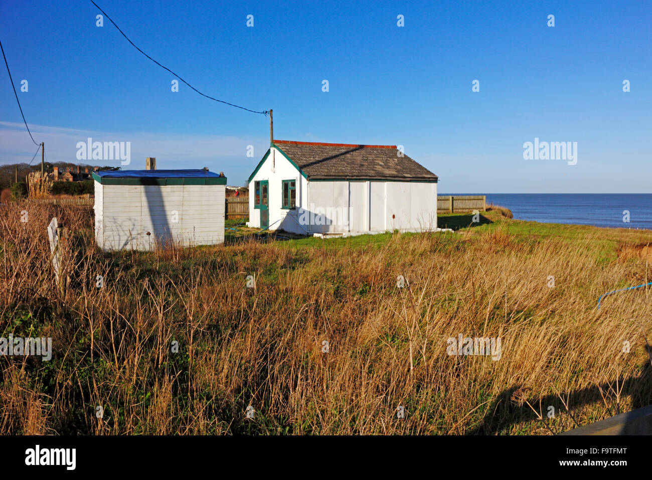 A view of a property on the edge of eroding cliffs at Happisburgh ...
