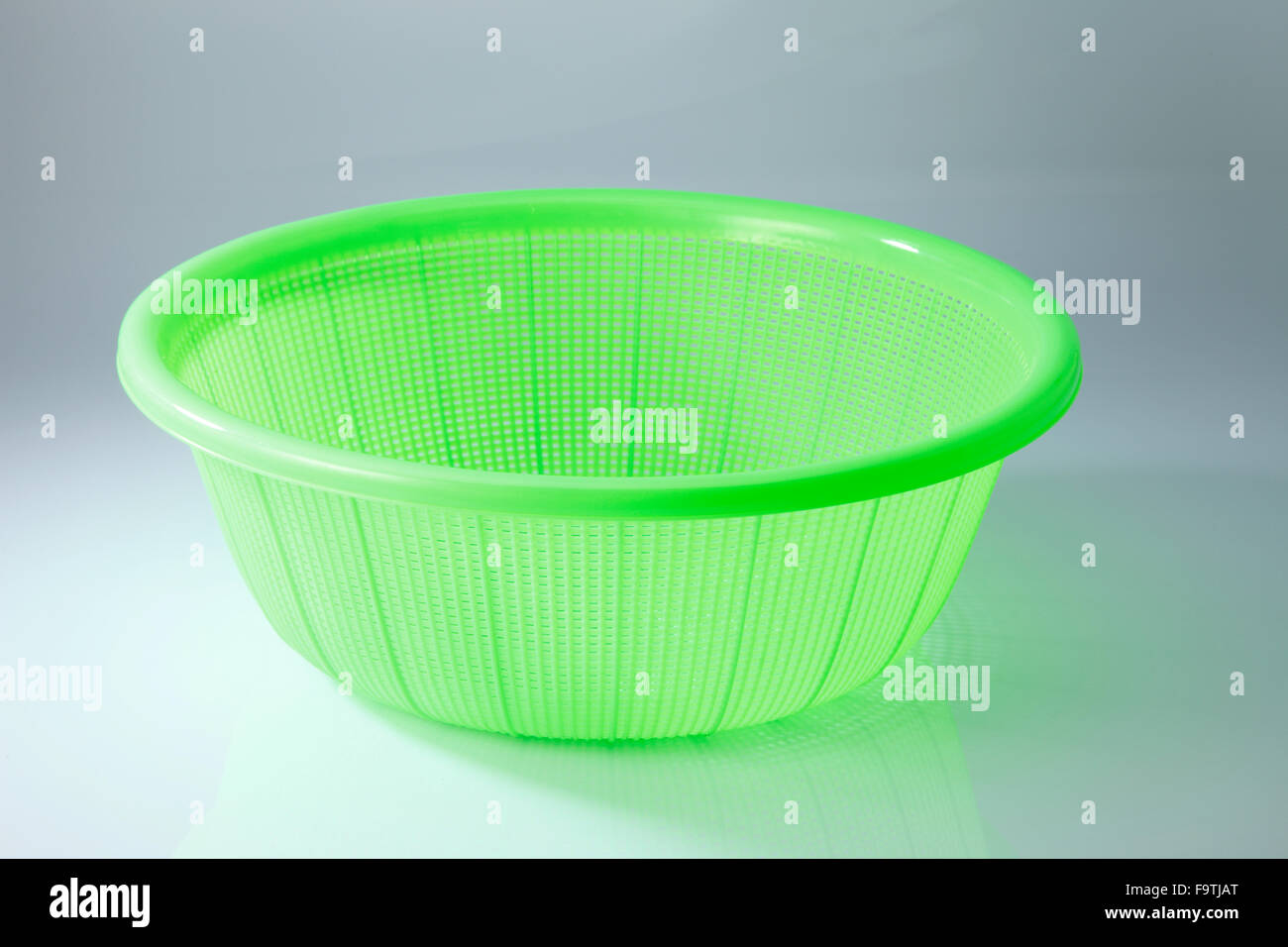 green plastic basket on a white background Stock Photo