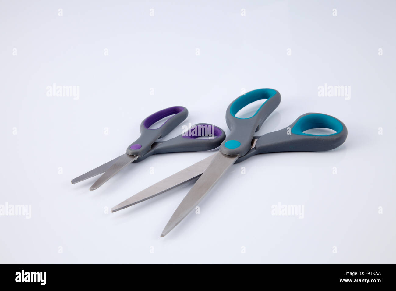 two pair of scissors which one big and small on the white background Stock Photo