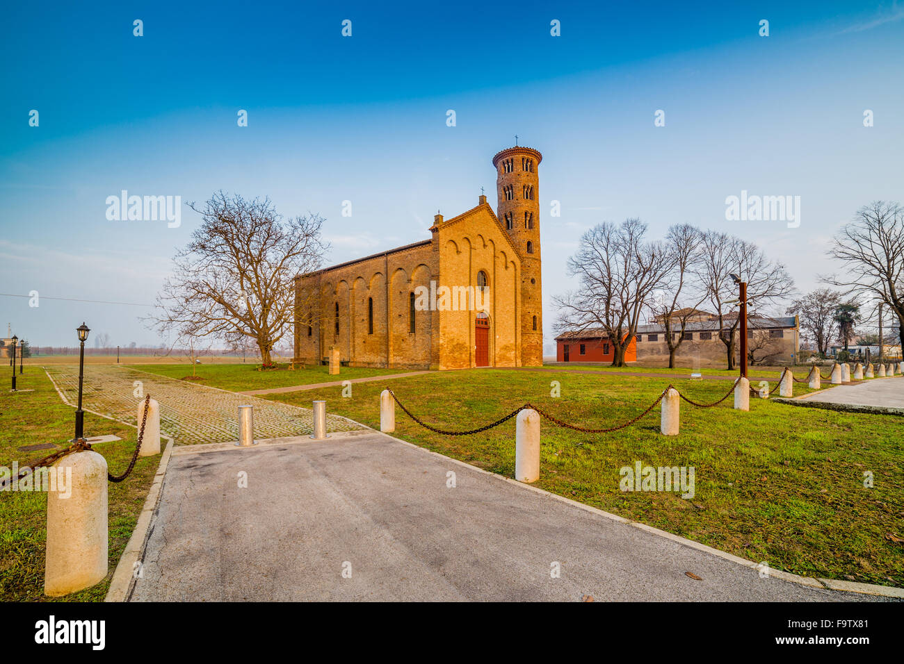 Ancient brick walls of an old Catholic church with one of the oldest  belltowers in Italy Stock Photo