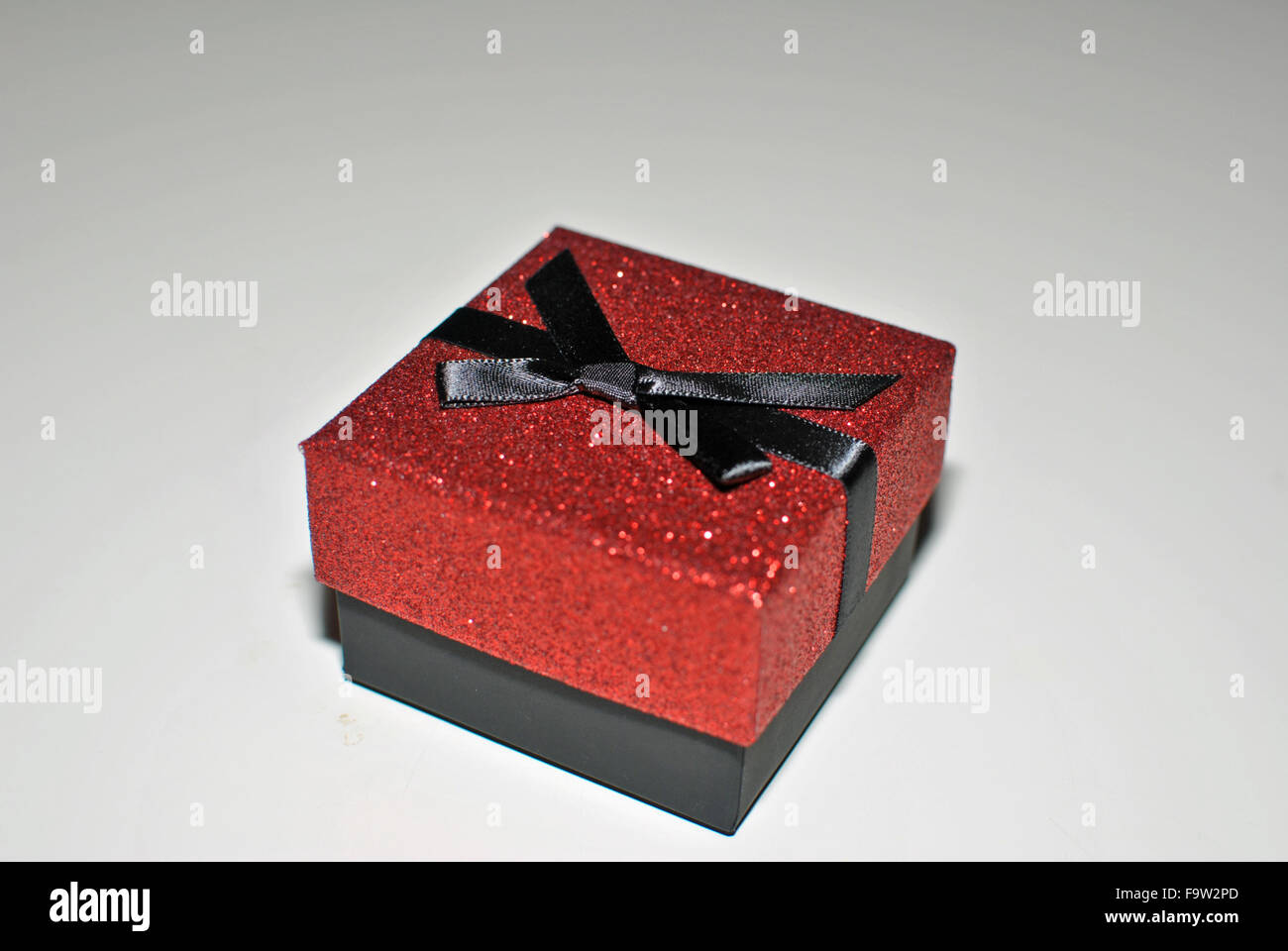 present in red box with black bow Stock Photo - Alamy