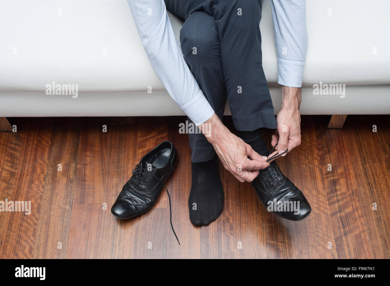 man who ties his black shoes Stock Photo