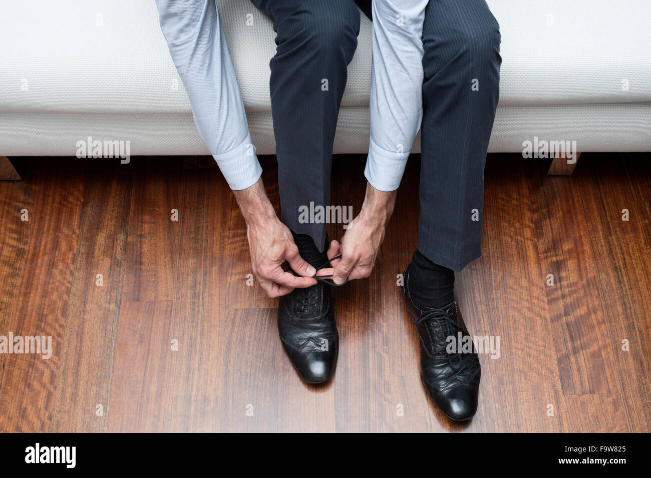 man who ties his black shoes Stock Photo