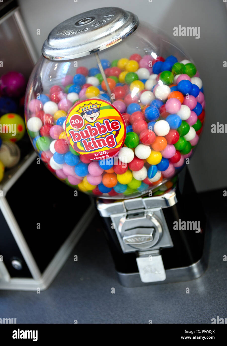 Colourful traditional round bubble gum in coin operated candy dispensing machine in shopping centre Stock Photo