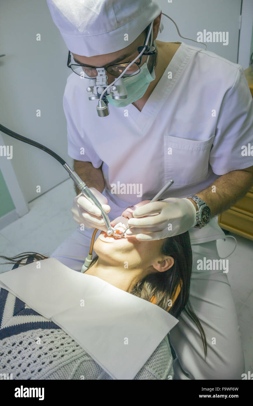 Dentist making a dental cleaning in a clinic Stock Photo Alamy