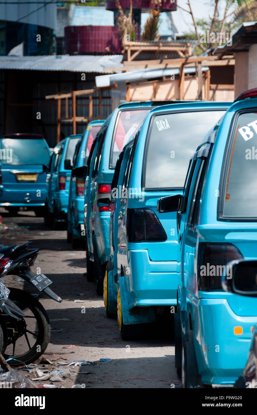 Lots of Blue transportation Vans in Queue on the street Stock Photo - Alamy