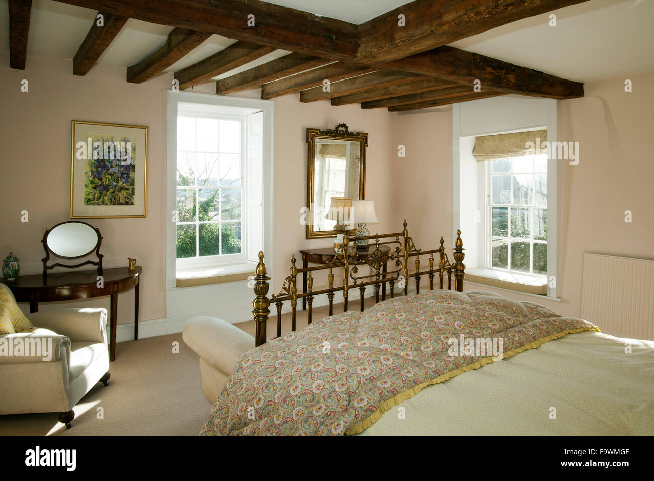 Traditonal bedroom with double aspect windows. Stock Photo