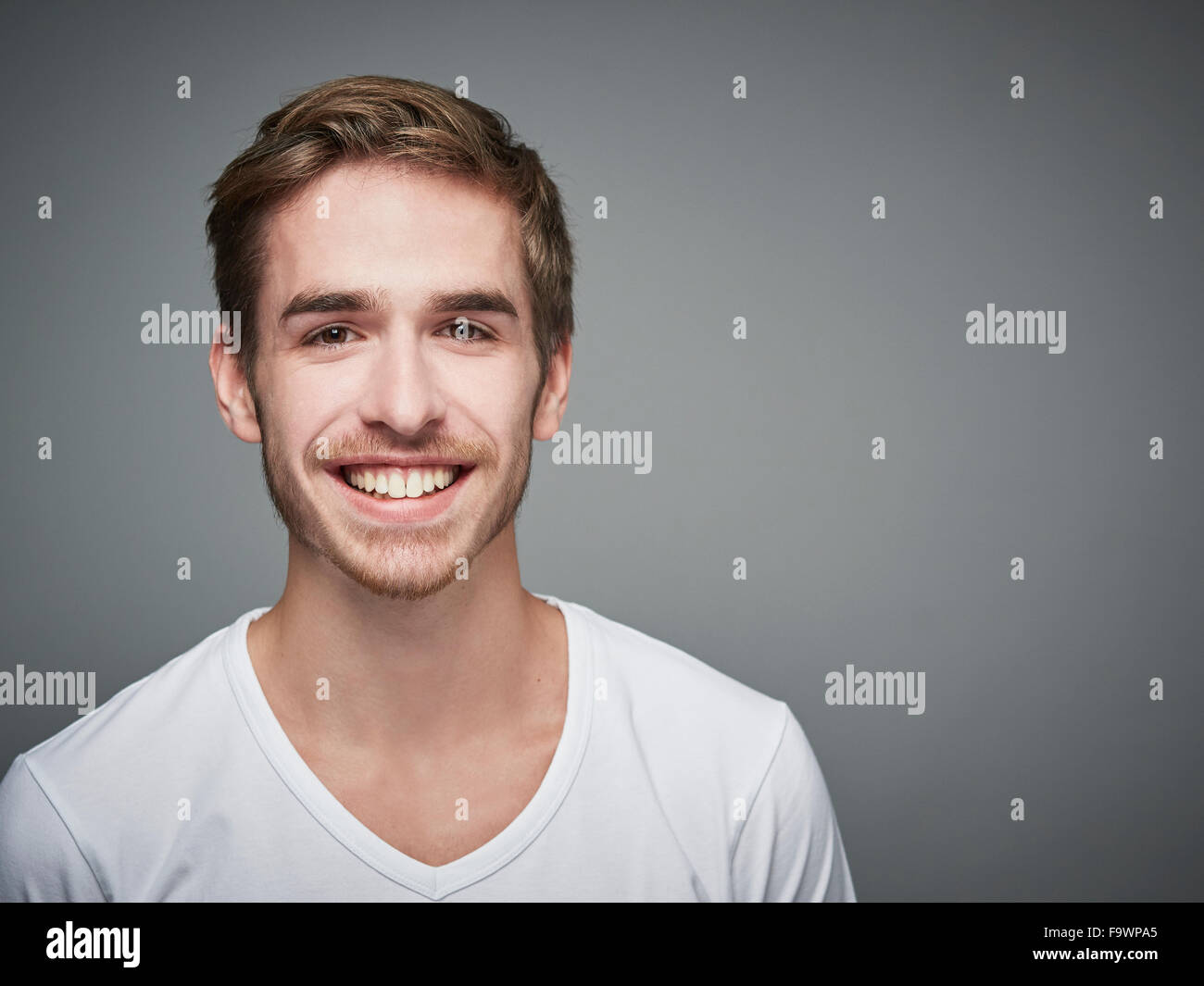 Portrait of smiling young man Stock Photo - Alamy