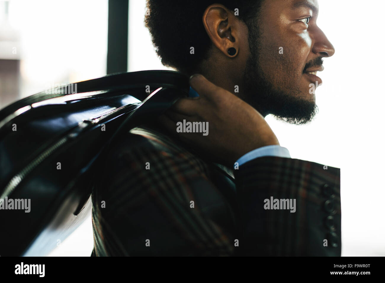 Young businessman carrying a bag Stock Photo - Alamy