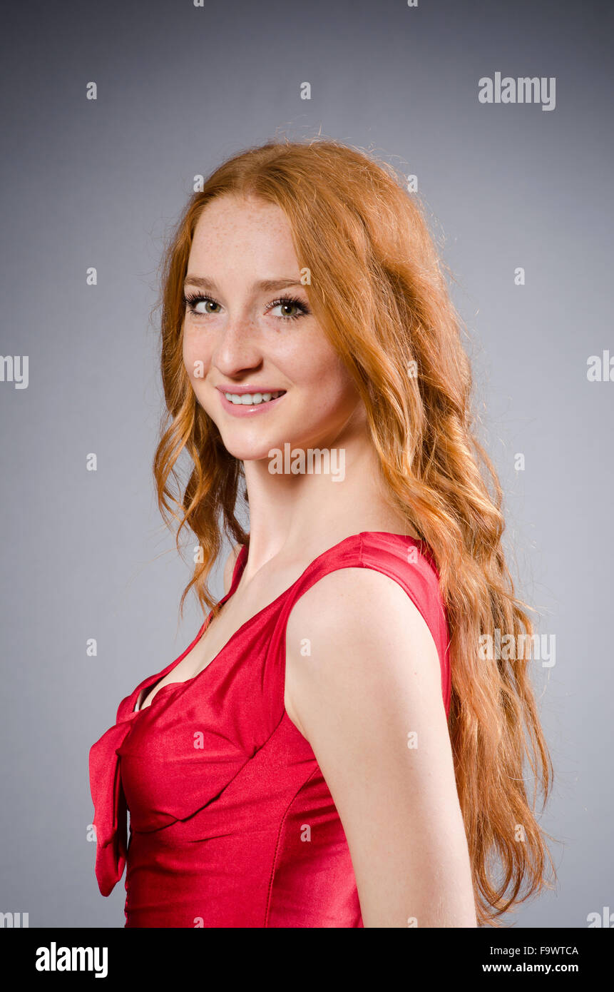 Girl in red dress against gray Stock Photo Alamy