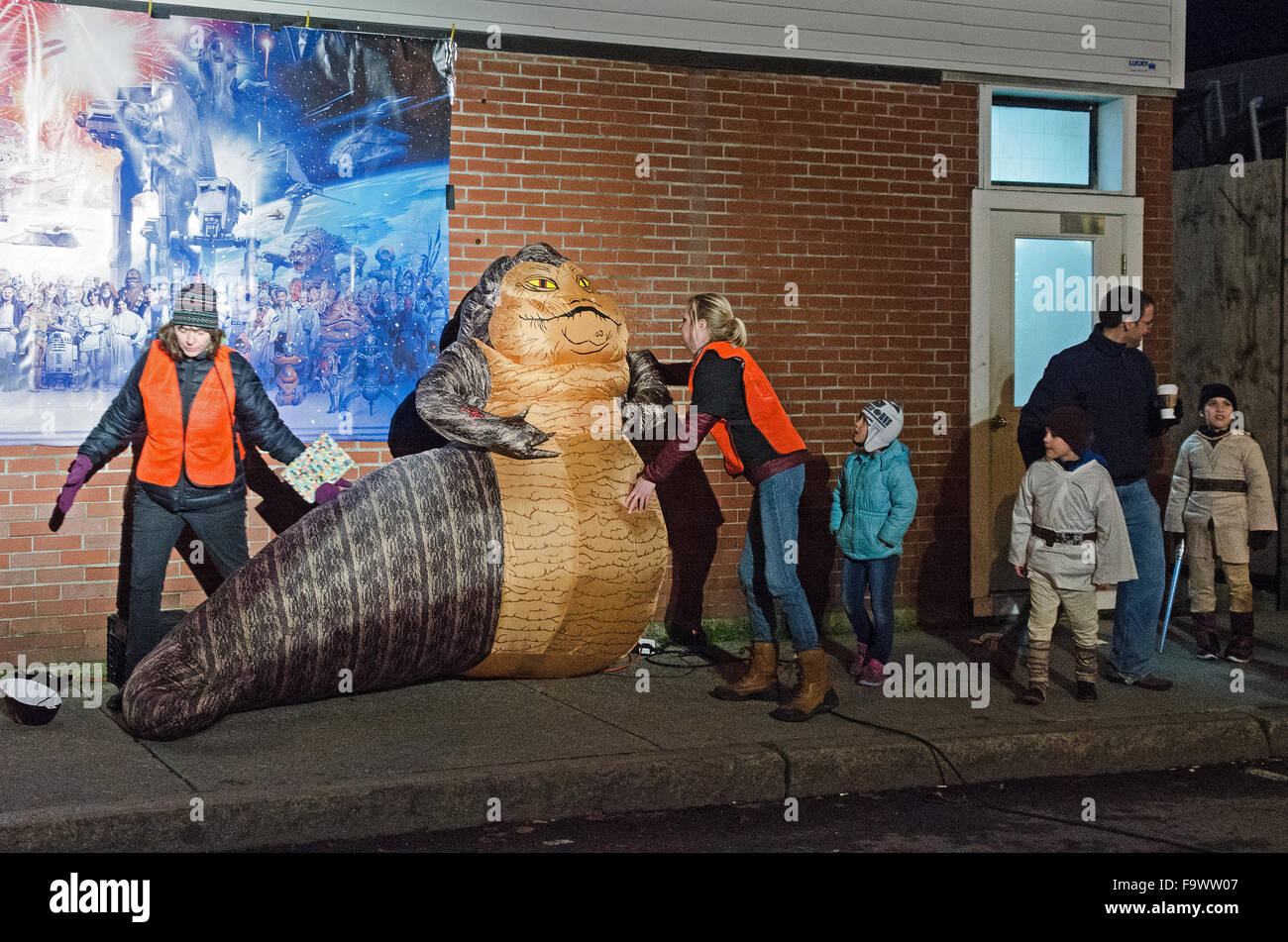 Bar Harbor, Maine, USA. 18th December, 2015. Fans watch workers setting up an inflatable Jabba the Hutt for the opening night of Star Wars: The Force Awakens at the historic Criterion Theater.  Credit: Jennifer Booher/Alamy Live News Stock Photo