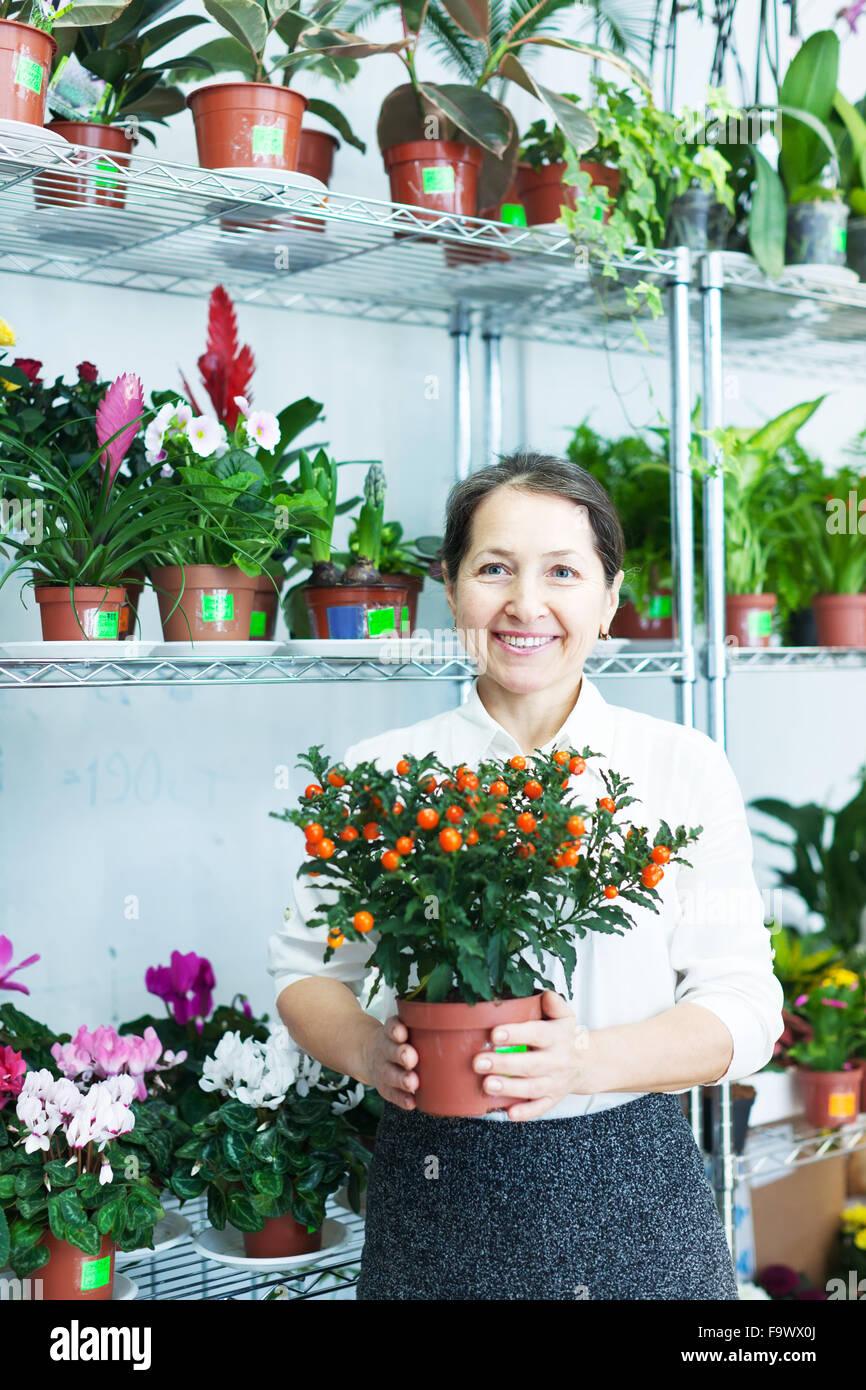 Female florist with Calamondin at flower store Stock Photo