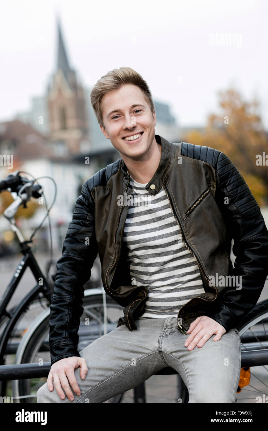 Portrait of smiling young man outdoors Stock Photo - Alamy