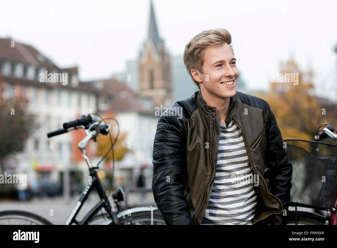 Portrait of smiling young man outdoors Stock Photo - Alamy