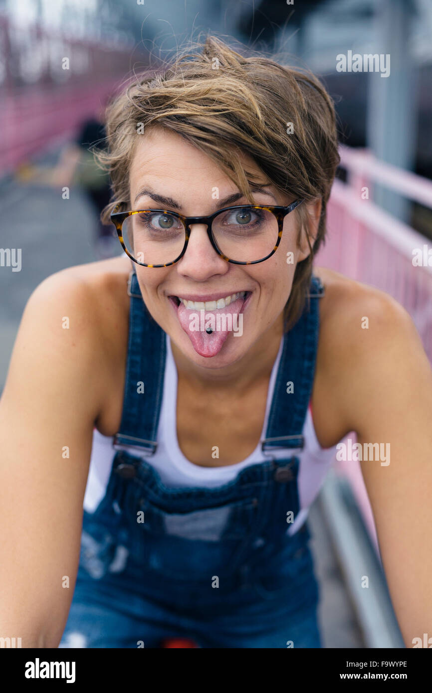 Portrait of woman showing her pierced tongue Stock Photo