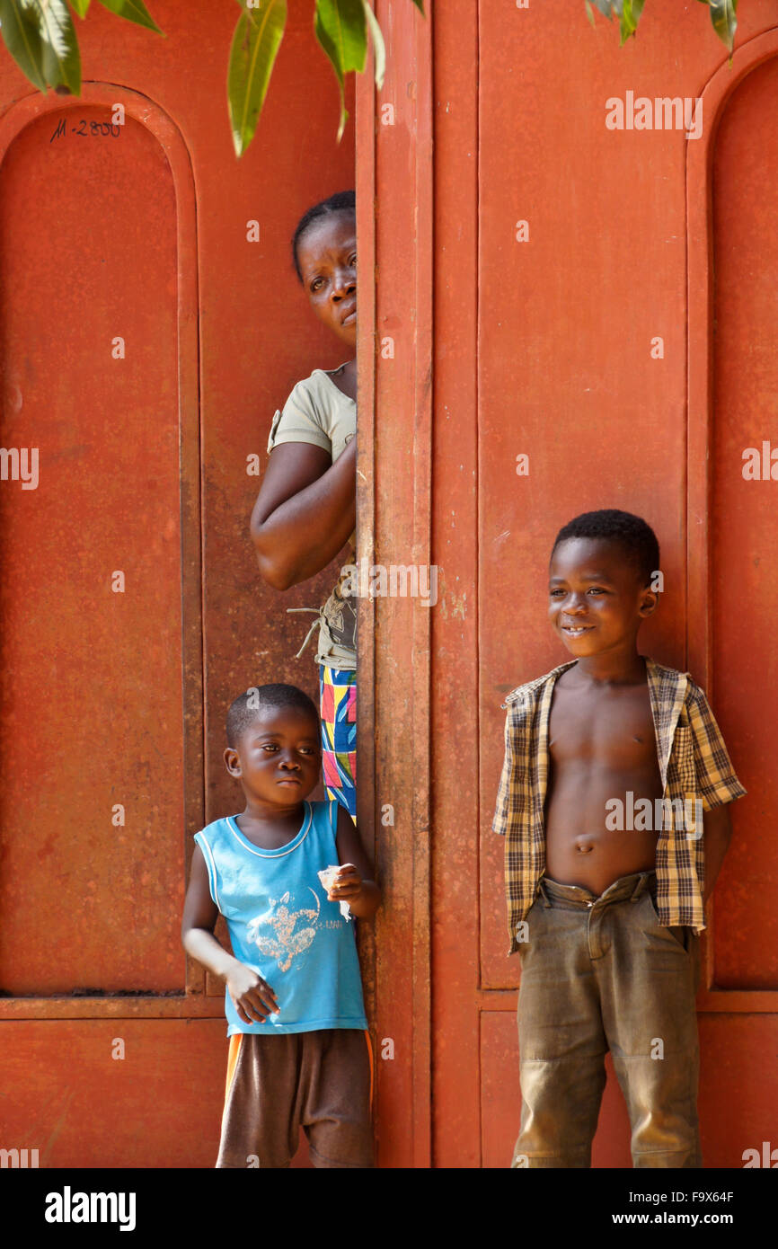 Woman and children in front their home, Lome, Togo Stock Photo