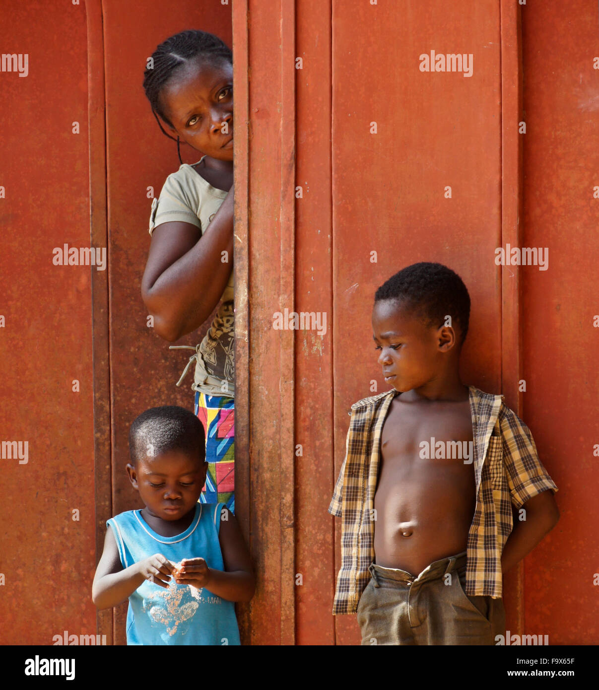 Woman and children in front their home, Lome, Togo Stock Photo