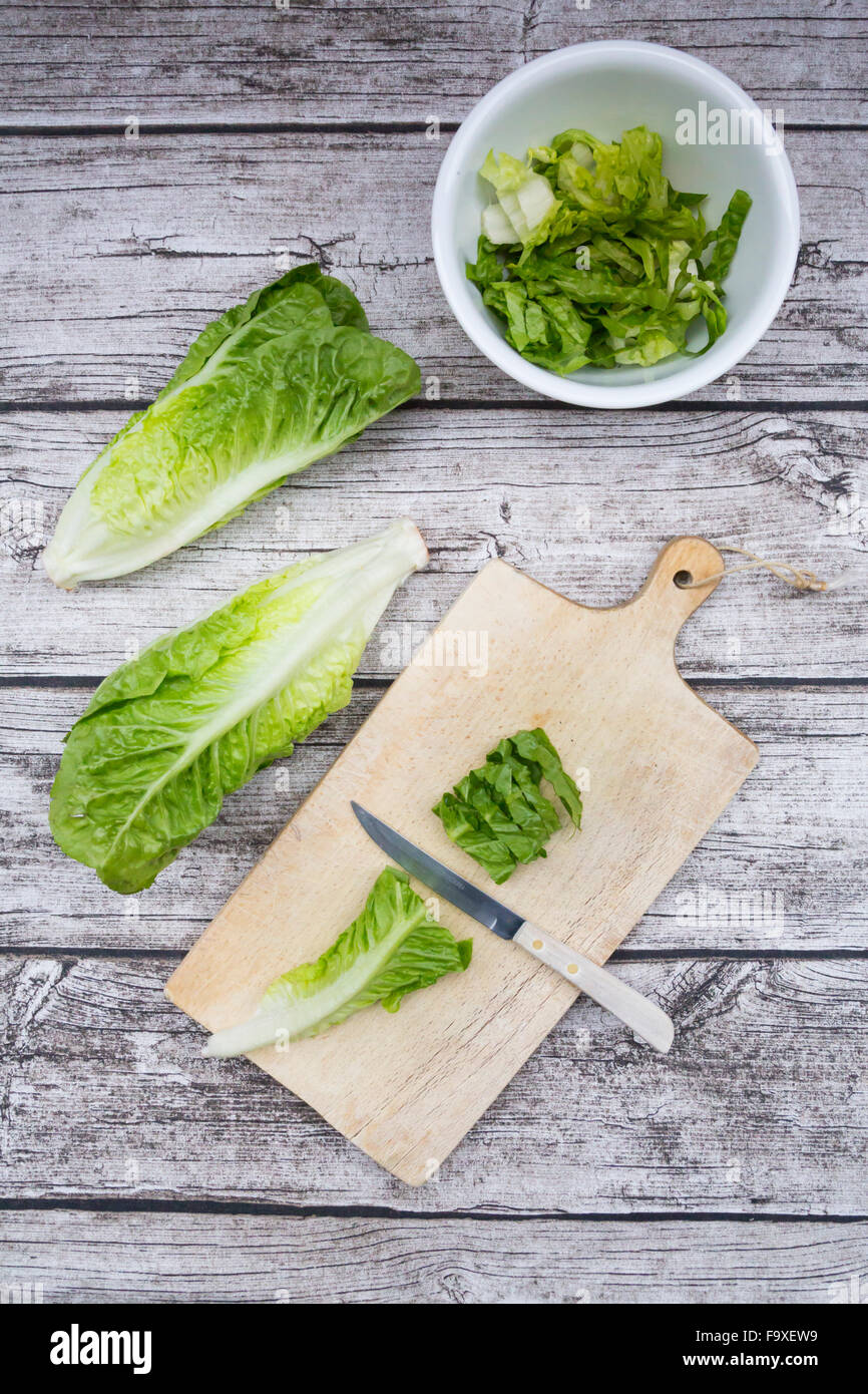 Chopped romaine lettuce and kitchen knife wooden board Stock Photo - Alamy