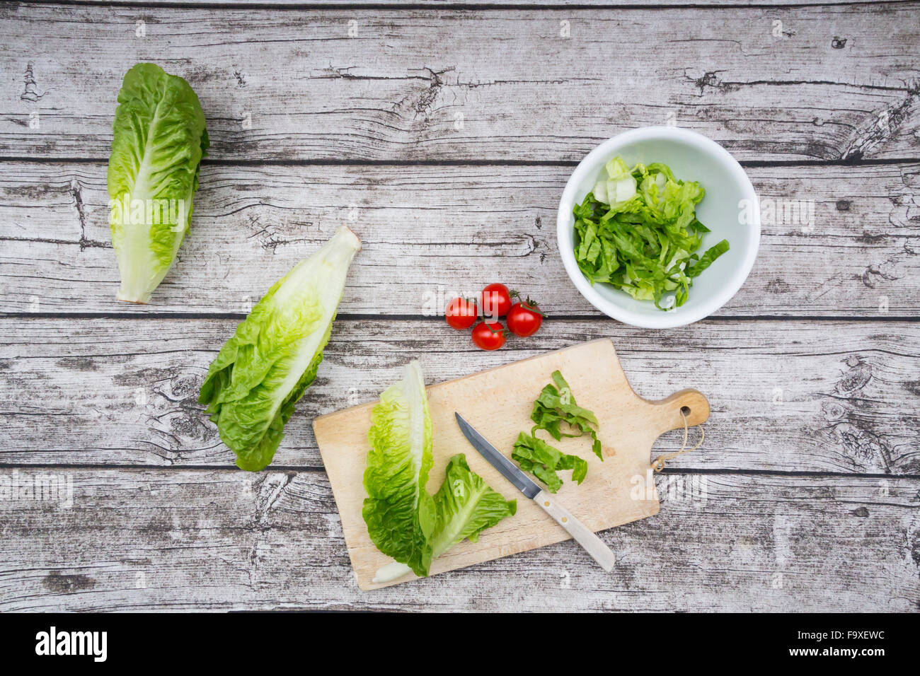 Chopped romaine lettuce and kitchen knife wooden board Stock Photo - Alamy