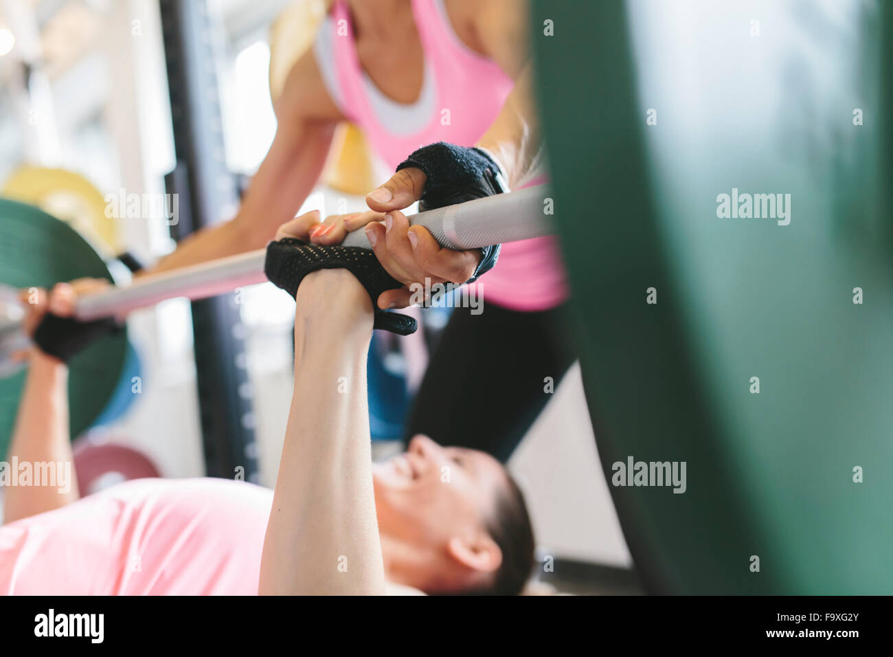 Two women doing barbell bench presses in a power rack Stock Photo Alamy
