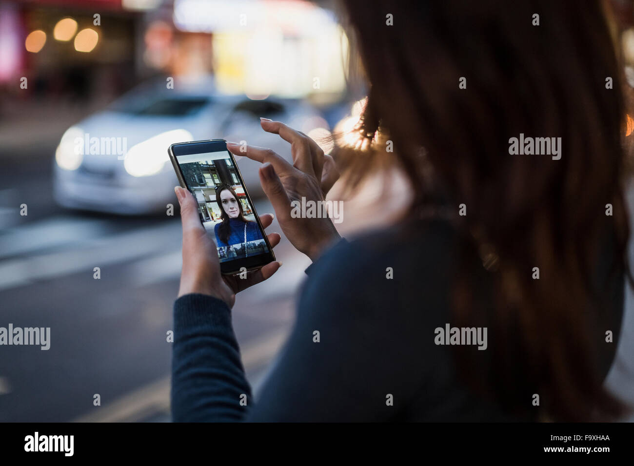 Woman taking a selfie by the roadside Stock Photo