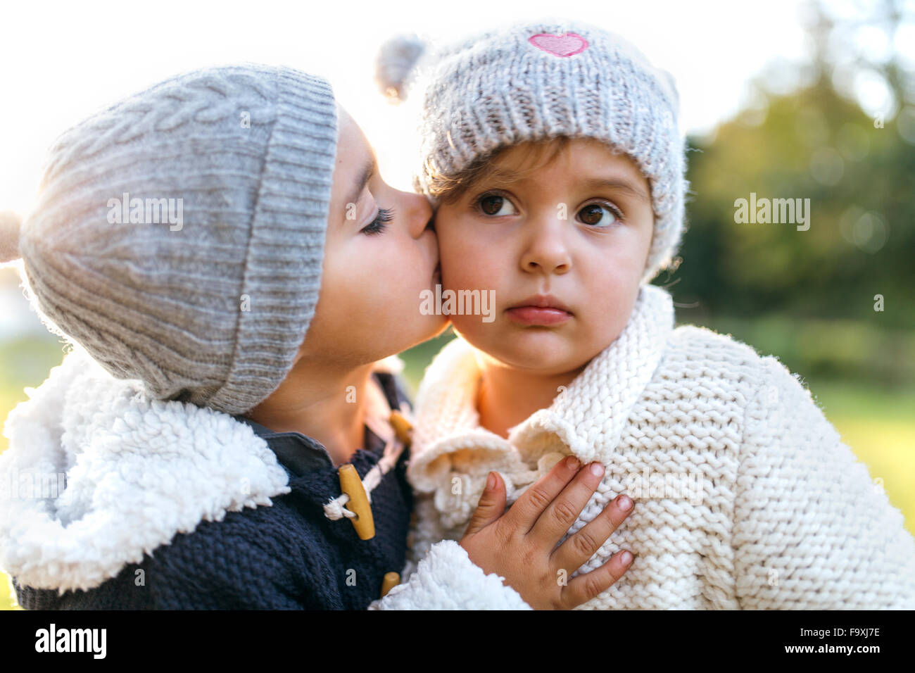Little girl kissing another little girl Stock Photo Alamy
