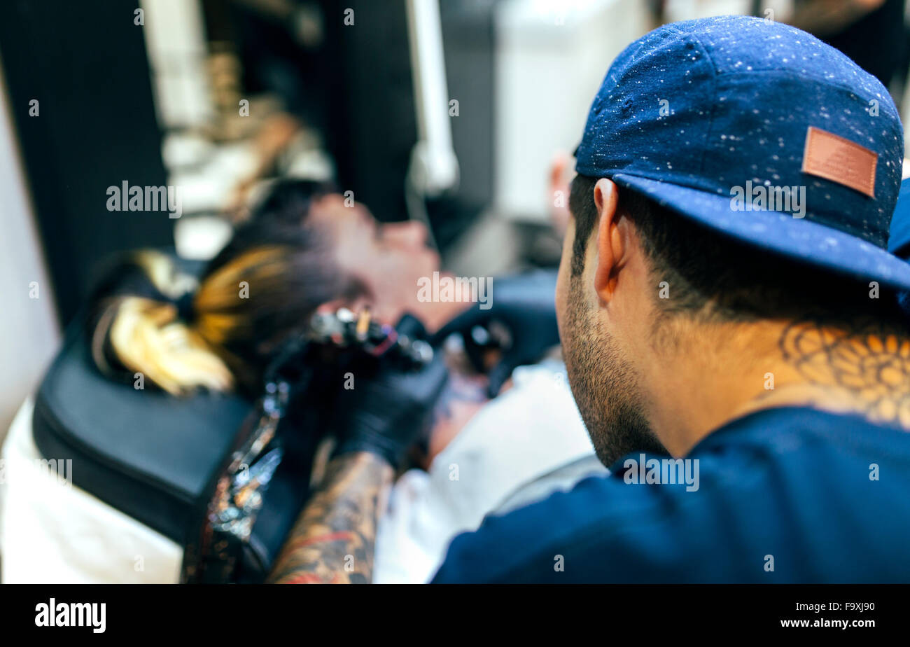 Tattoo artist on man shoulder hi-res stock photography and images - Alamy