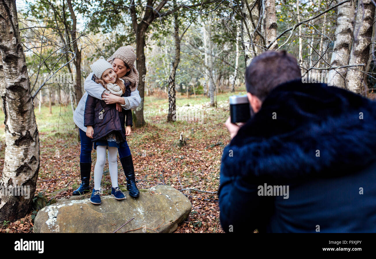 Father taking picture of wife and daughter in the forest Stock Photo ...