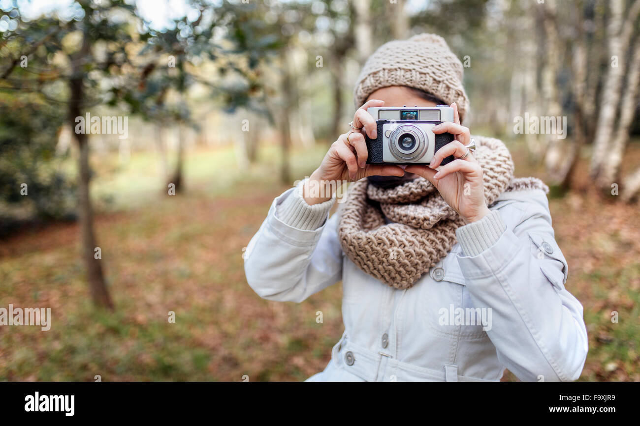 Woman taking a picture in the forest Stock Photo - Alamy