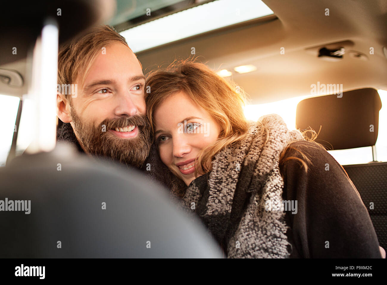 Happy couple cuddling in a car Stock Photo Alamy