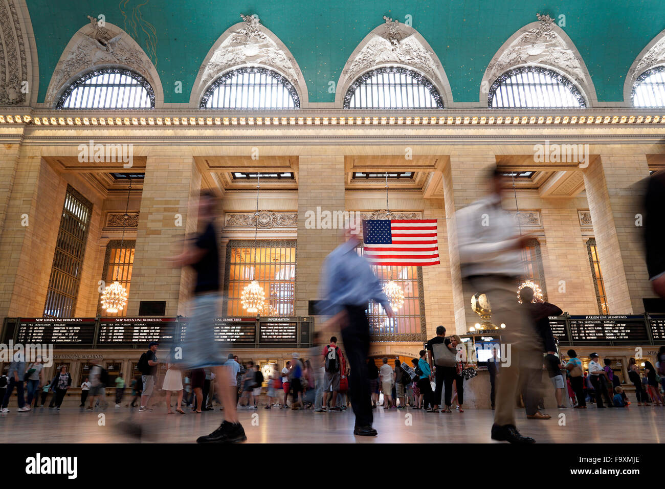 Interior low angle view of the main concourse of Grand Central Terminal with commuters in New York City, USA Stock Photo
