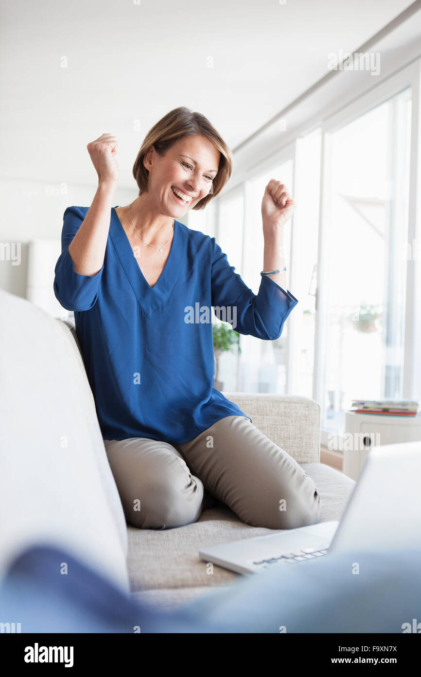 Happy woman at home shopping online Stock Photo