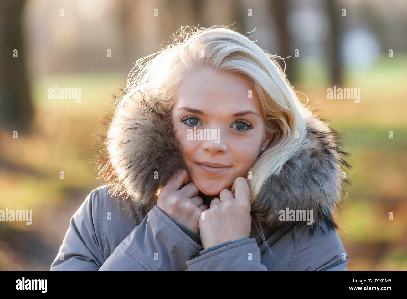 Portrait of smiling young blond woman in autumn Stock Photo - Alamy