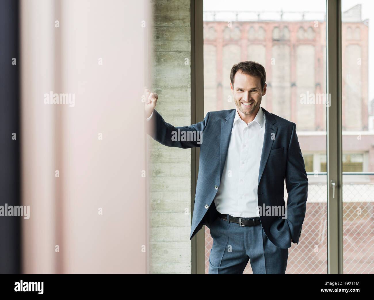 Portrait of smiling businessman wearing suit Stock Photo - Alamy