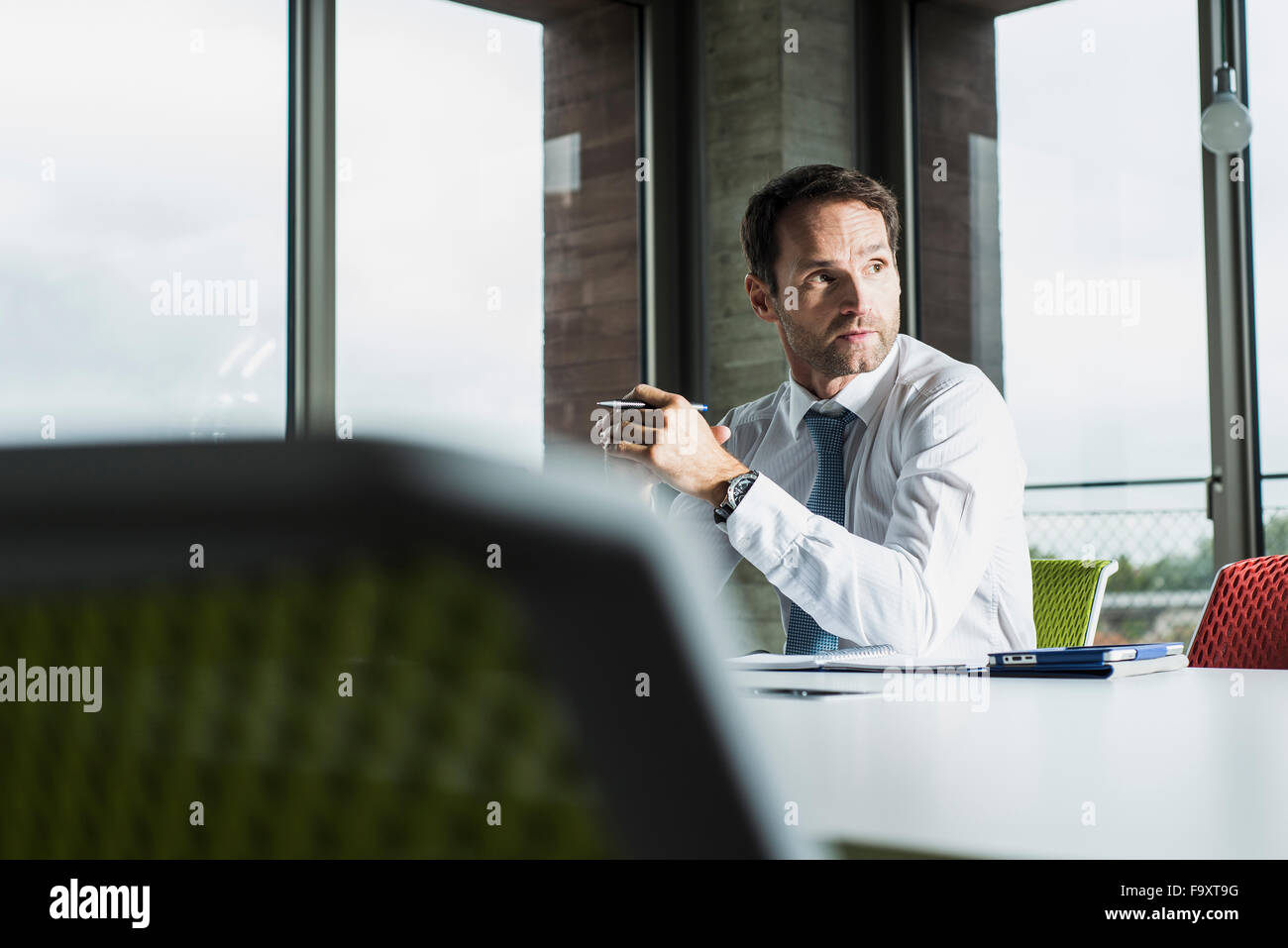Portrait of businessman at his desk in the office Stock Photo