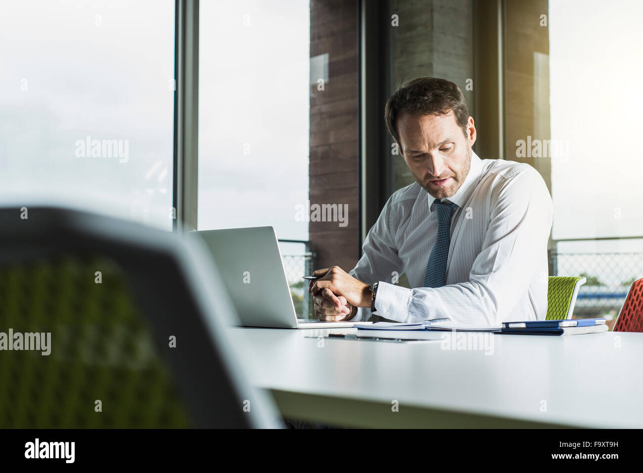 Portrait of businessman at his desk in the office Stock Photo Alamy