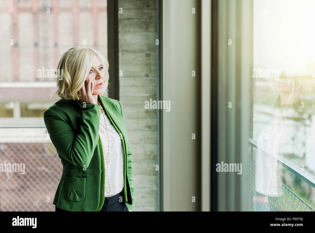 Portrait of blond businesswoman telephoning with smartphone Stock Photo