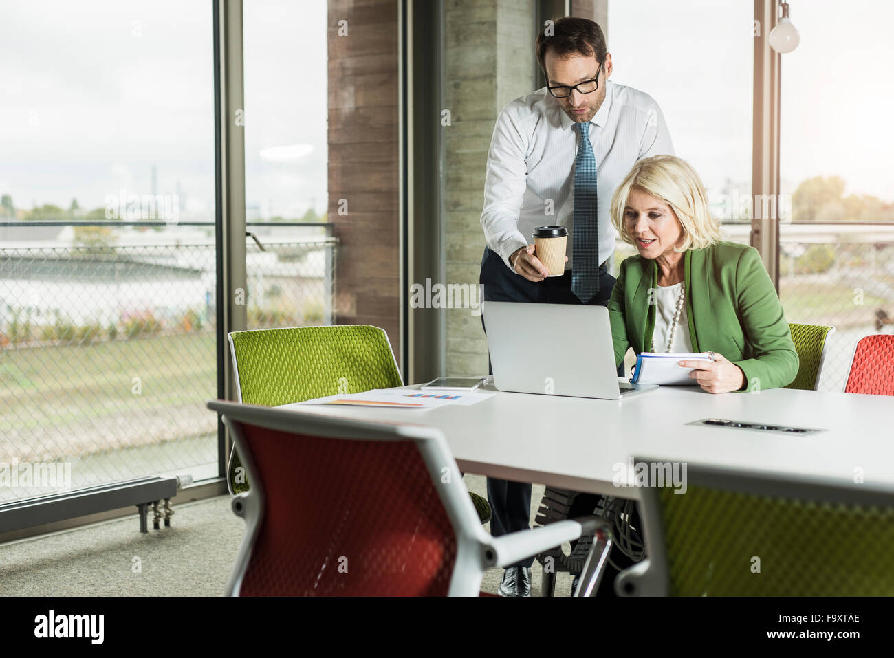 Two business people looking at laptop in an office Stock Photo