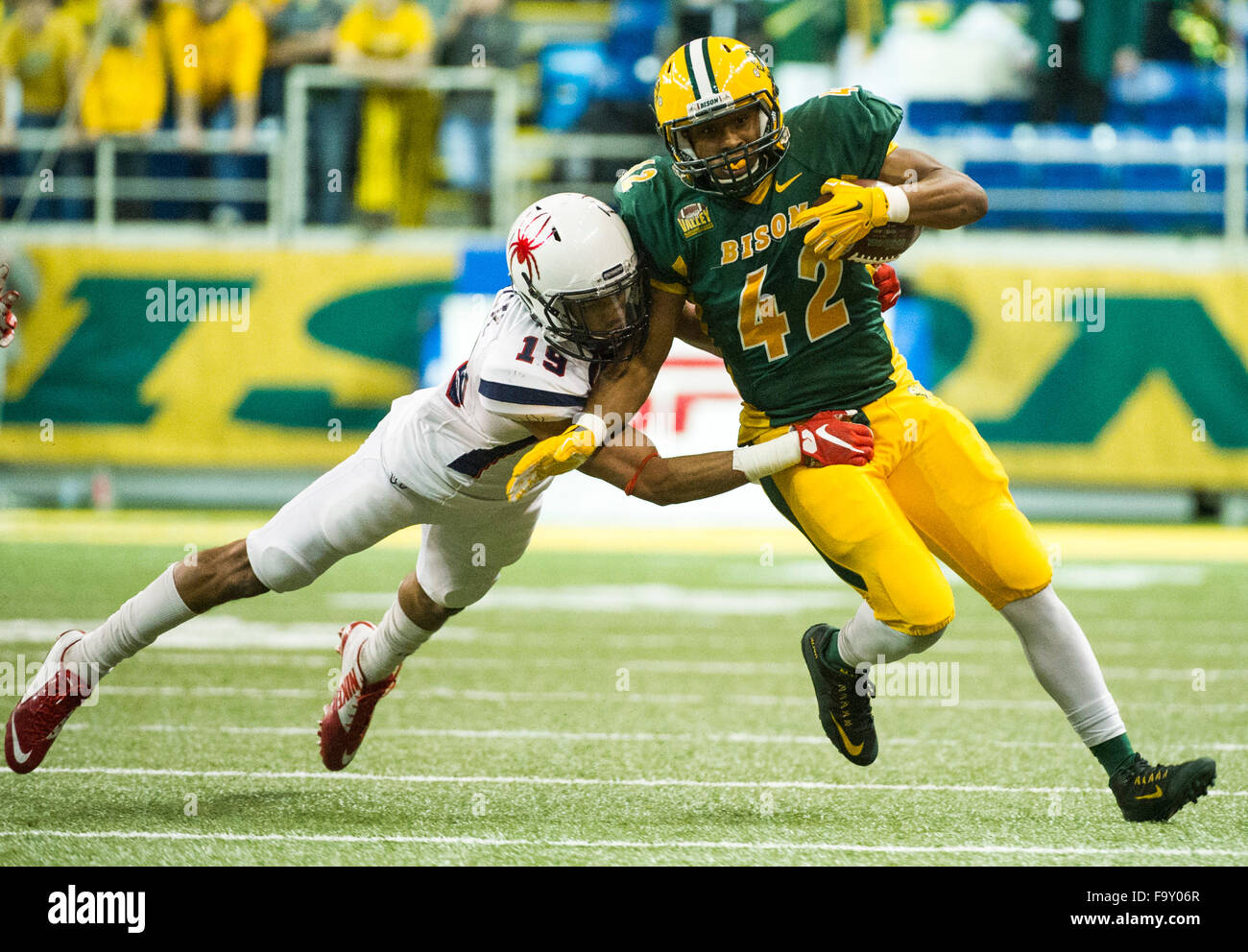 Fargo, North Dakota, USA. 18th Dec, 2015. December 18, 2015: Richmond defensive back Charles Mack (19) tackles North Dakota State running back Bruce Anderson (42) during the third quarter of an NCAA FCS semifinal game at the Fargodome in Fargo, North Dakota, on Friday, Dec. 18, 2015. North Dakota State beat Richmond 33-7 to advance onto the FCS national championship game for the fifth straight year. Nick Wagner/CSM Credit:  Cal Sport Media/Alamy Live News Stock Photo