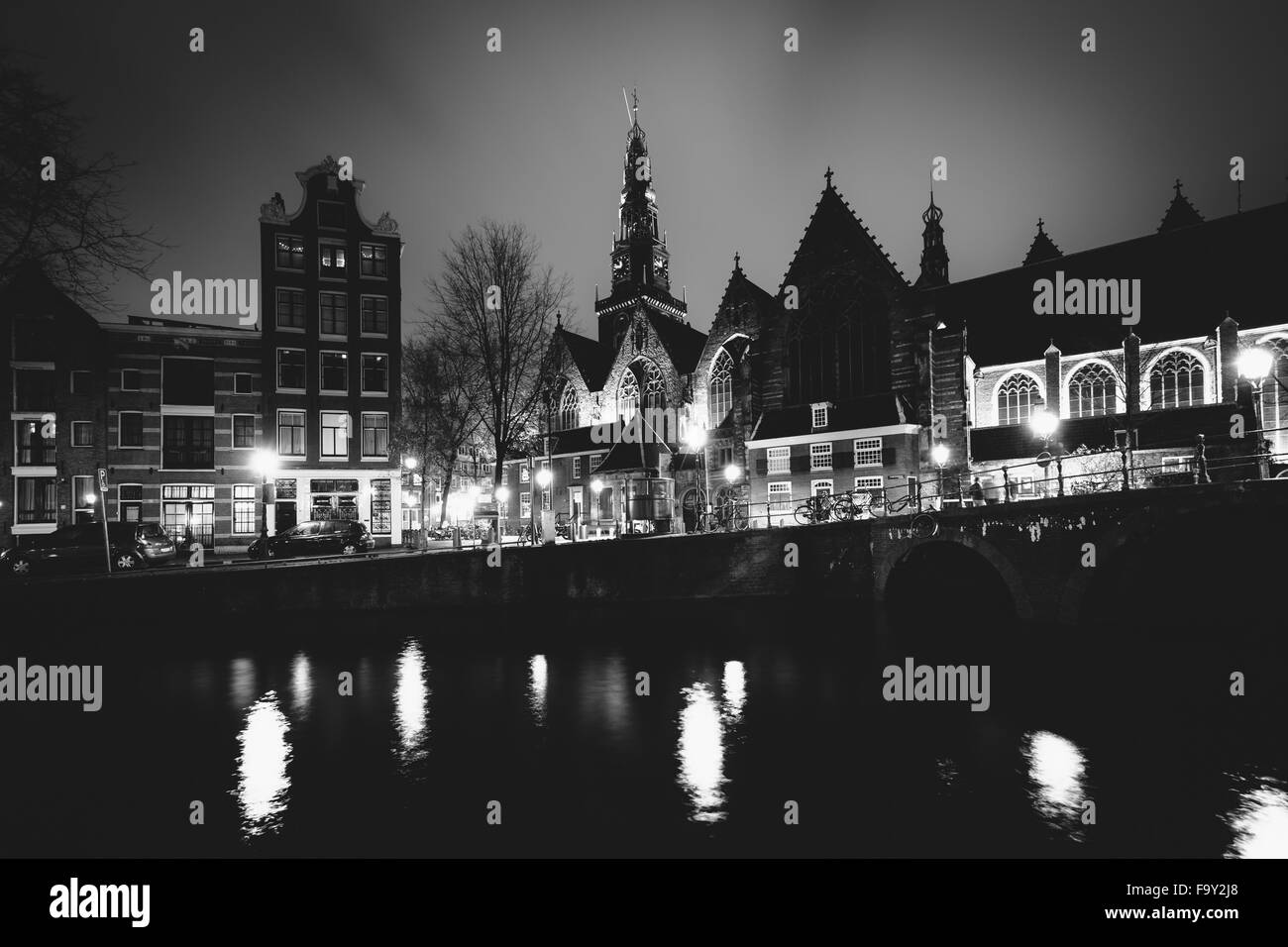 The Oude Church and a canal at night, in Amsterdam, The Netherlands. Stock Photo