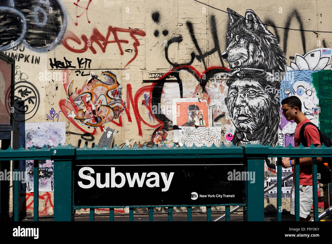 New York City subway station with graffiti in the background and subway rider walking down the stairs, USA Stock Photo