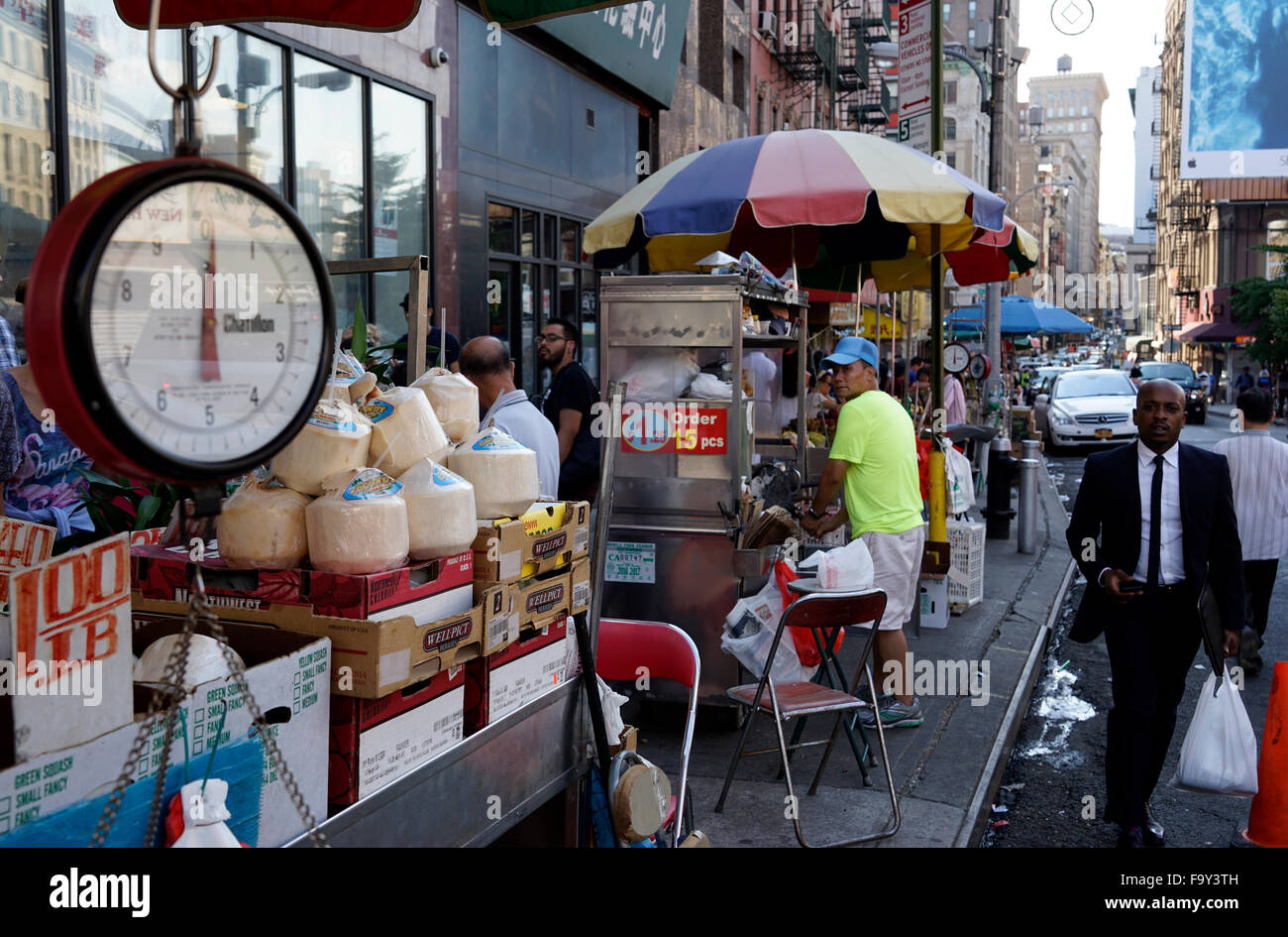 Food and grocery vendors crowd the sidewalk of New York City Chinatown, USA Stock Photo